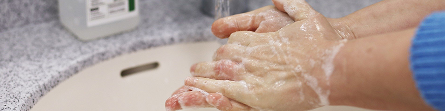 Hands putting on hand cream